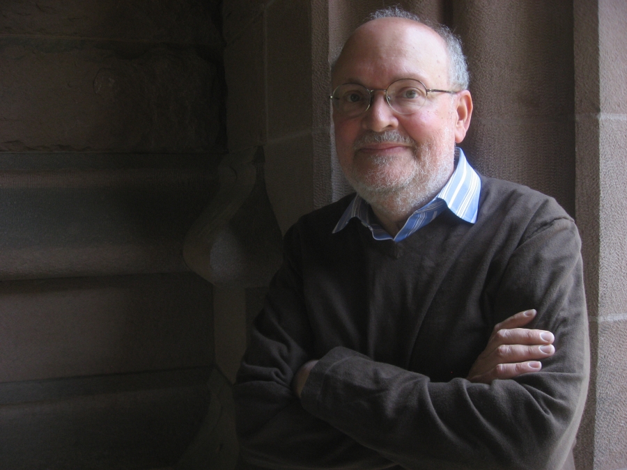 Leonard Barkan with arms crossed in an archway